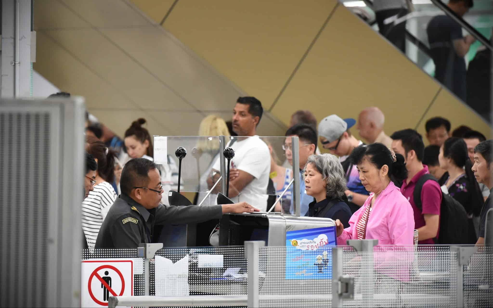 People queing at Thai immigration counter