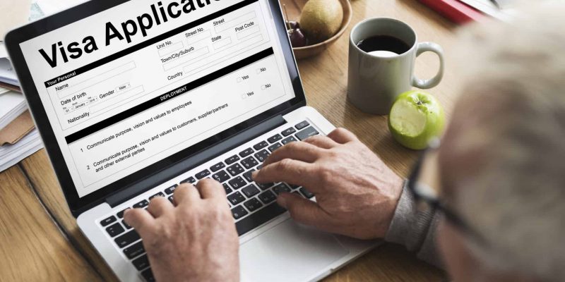A retiree filling out a Thai retirement visa application form online